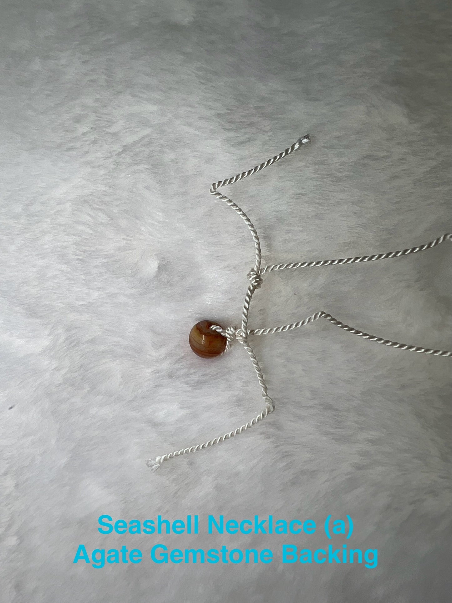 Genuine Seashell Necklace, wrapped on a 100% Silk Thread,  with a Geniune Agate Bead Enclosure